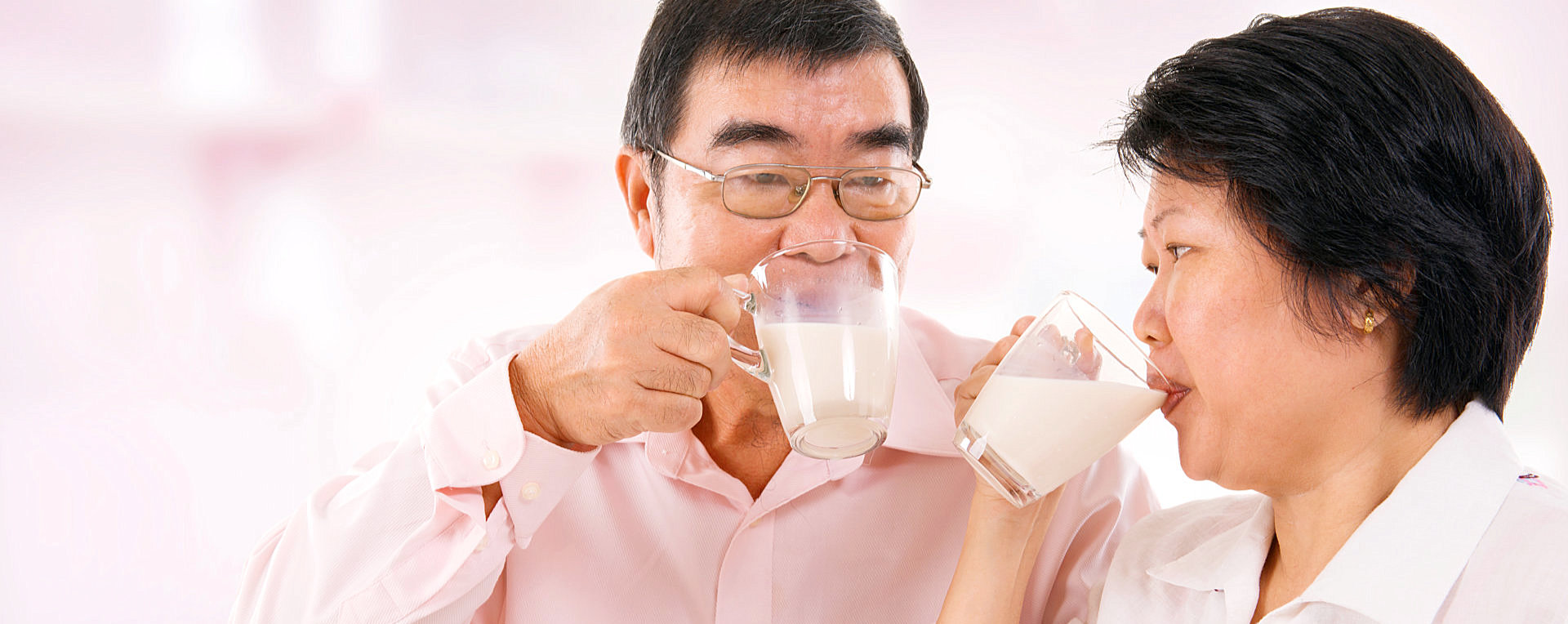 Elderly couple drinking a glass of milk